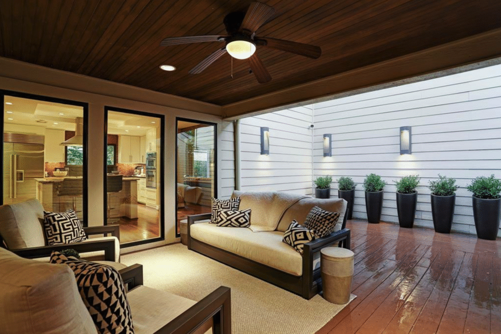 attached-patio-cover-flat-tg-ceiling-wood-deck Attached patio cover with a tongue and groove stained ceiling, stained wood deck, custom lighting, and a black ceiling fan.
