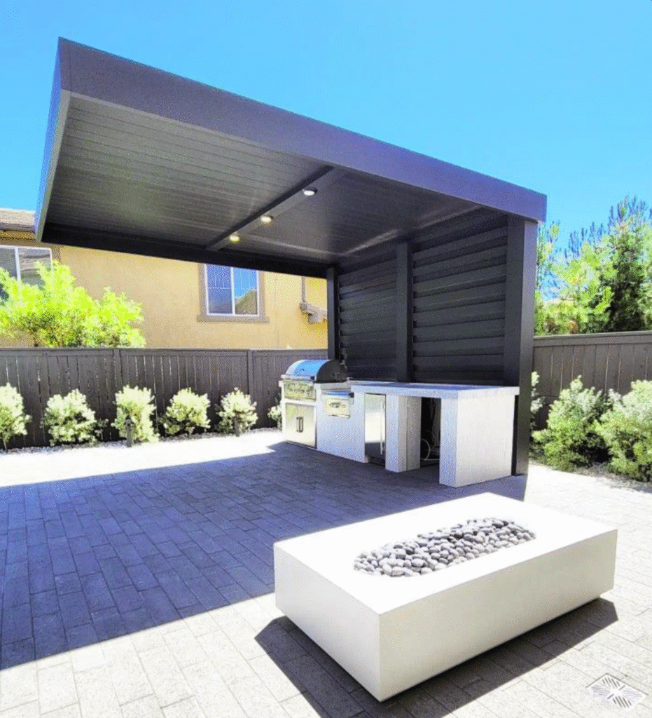 A luxury outdoor living space featuring a modern 4K Aluminum privacy wall, a sleek cantilever patio cover, a high-end outdoor kitchen, and a gas fire pit.