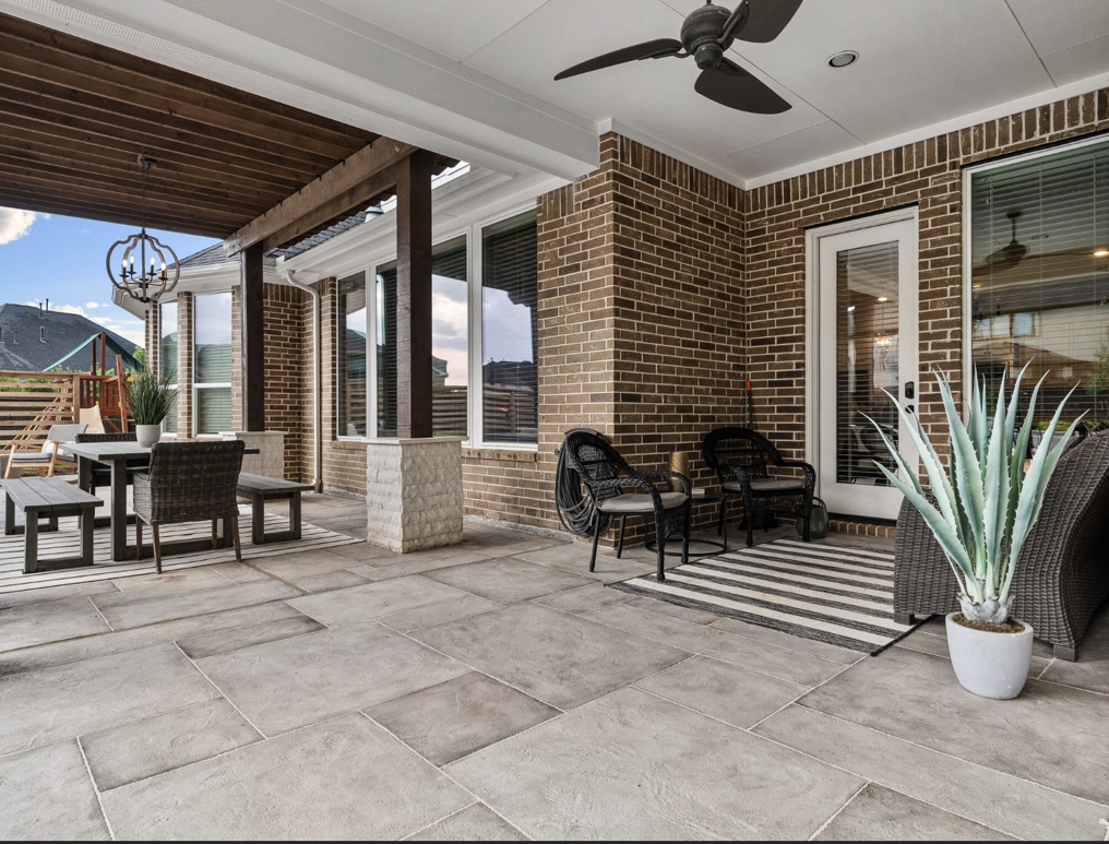 Hand-carved Roman stone pattern concrete overlay on a concrete patio deck.