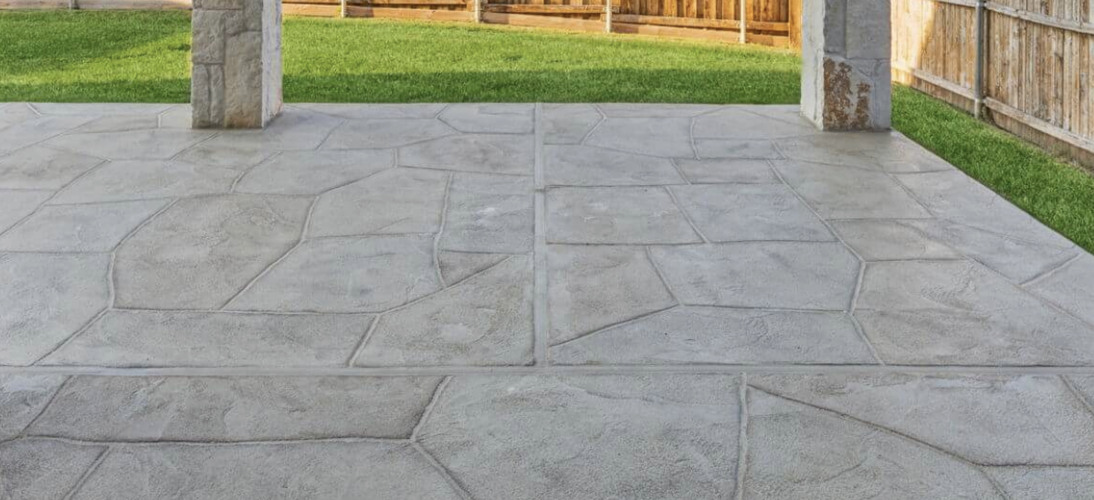 Hand-carved concrete overlay in a classic flagstone pattern with multi-tonal colors on a luxury residential patio