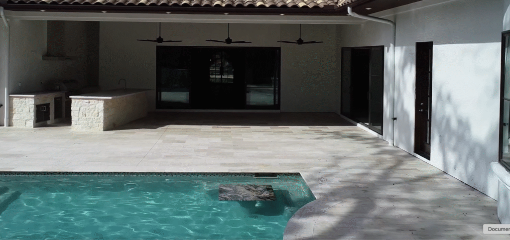 custom-luxury-pool-swim-up-bar-granite-countertop-tanglewood Custom luxury pool in Tanglewood featuring a swim-up dining table with a granite countertop.