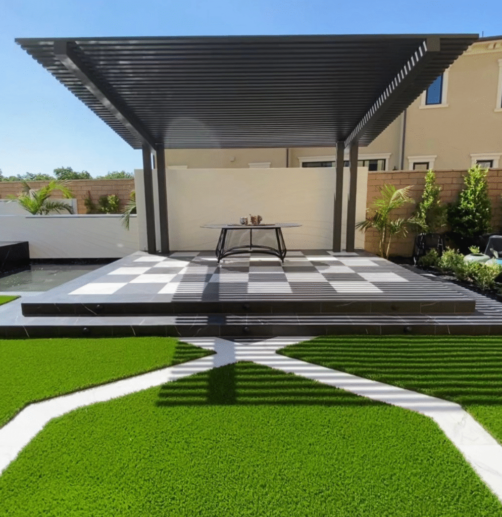 Bold Modern Luxury by Premier Houston Pergola Builders A modern sleek black cantilevered aluminum pergola projecting over an elevated stone seating area, showcasing post-free architectural engineering by specialized Houston pergola builders.