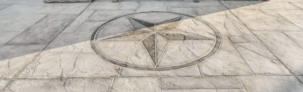 A decorative concrete overlay featuring a custom hand-carved star medallion inlay, showcasing high-end craftsmanship from premier Houston concrete resurfacing contractors.