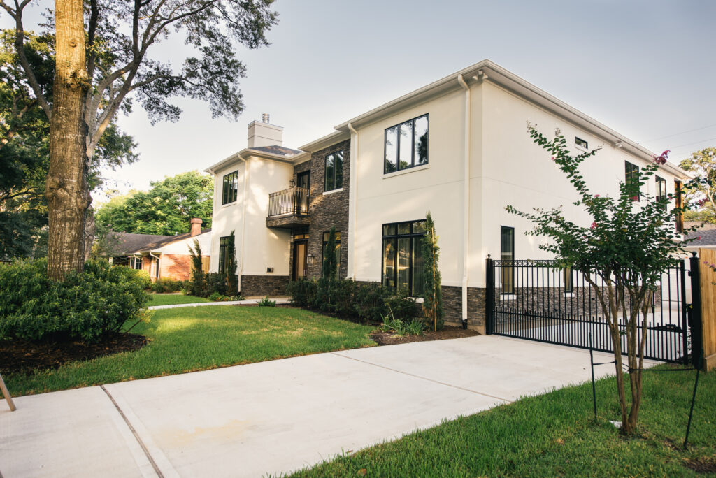 Professional pavers and concrete construction in Houston by Luxscape, featuring a concrete driveway and modern access gate at a contemporary home in the Briargrove subdivision.