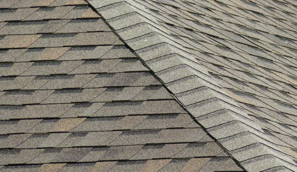 A close-up of architectural composition shingles meeting at a hip ridge, Luxscape Outdoor Builders serving Houston, TX.